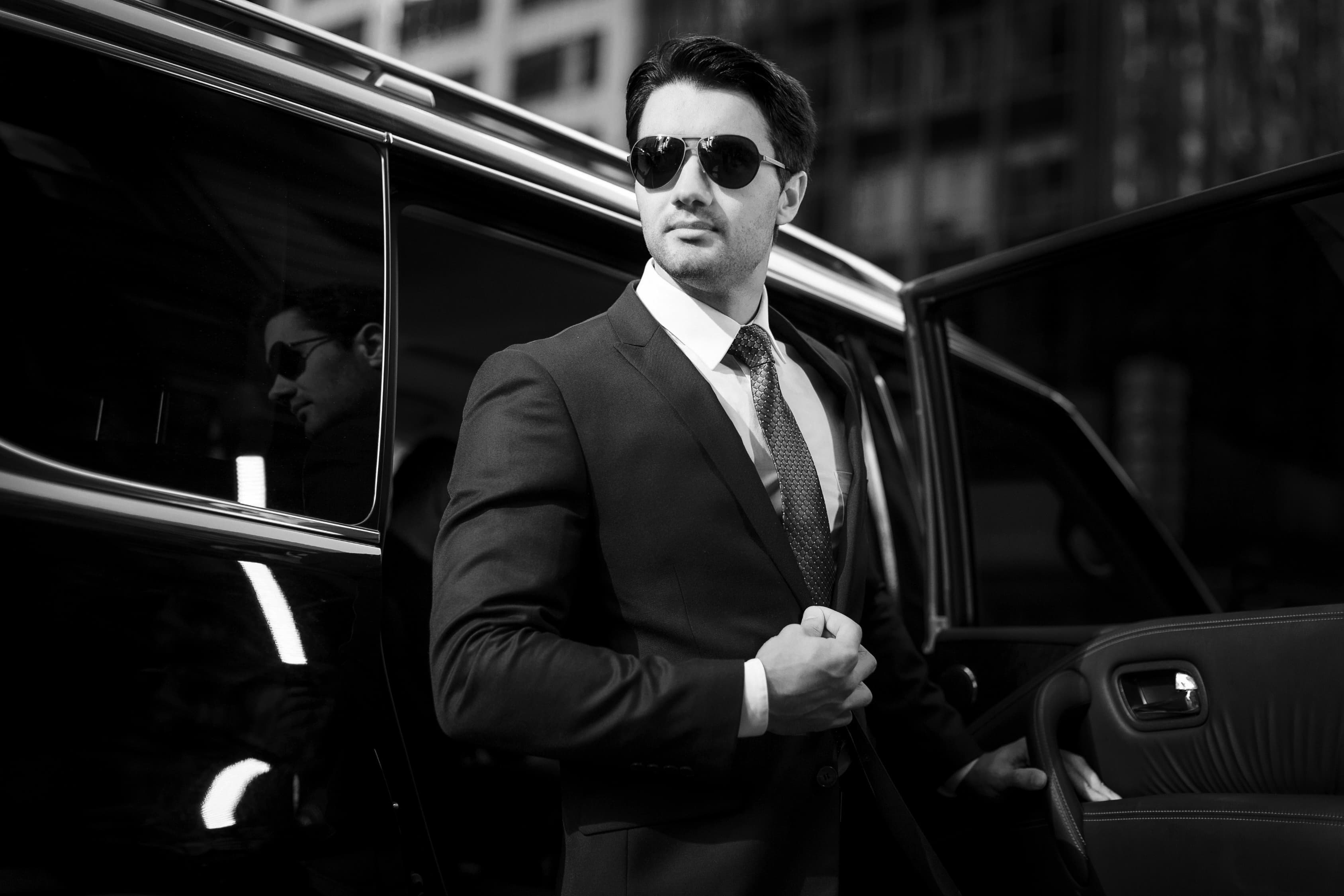 A business leader stepping out of a car